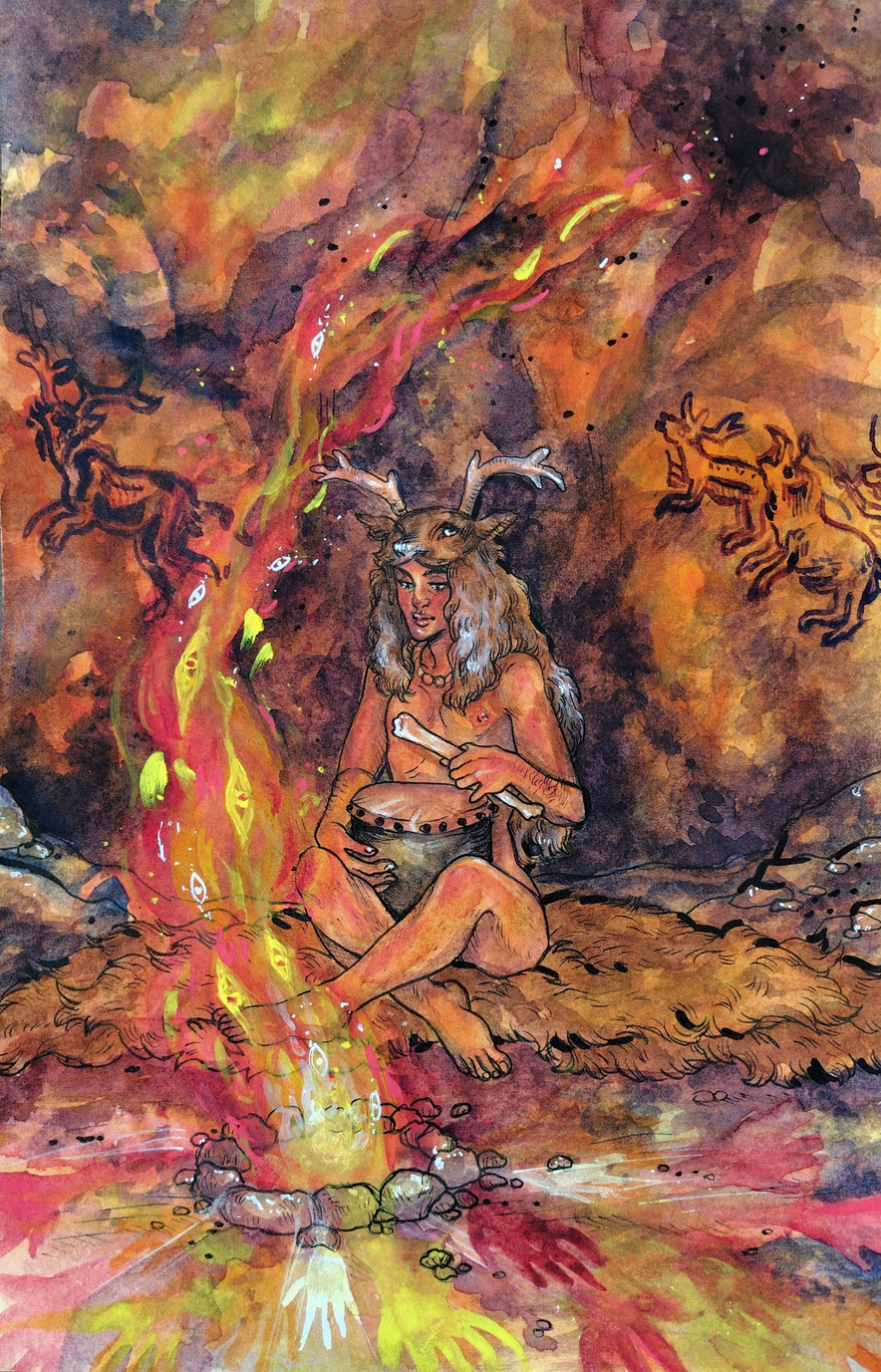 A male figure sits cross-legged in front of a fire. He wears a deer skin headdress and is holding a primitive drum. He is in a cave and there are paintings on the walls behind him. Handprints surround the fire pit in red, yellow, and white.